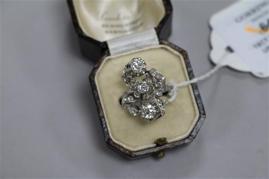 An 18ct white gold and diamond cluster upfinger ring, size M.